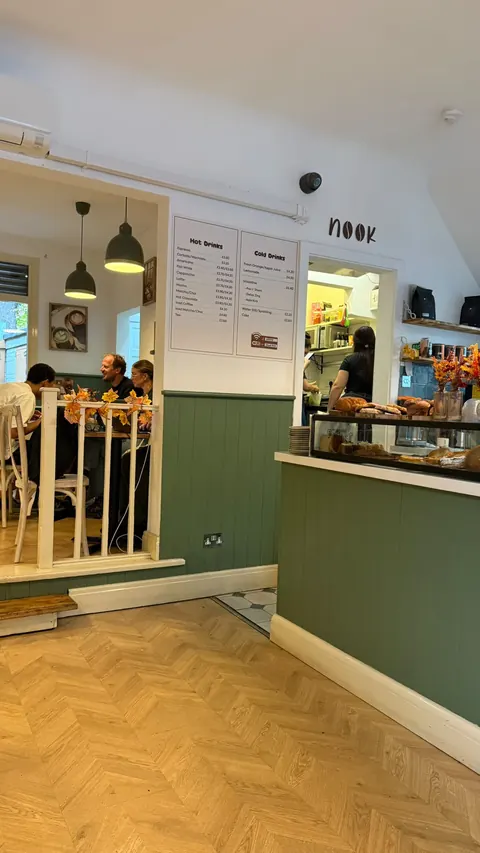 Nook’s counter with cakes, pastries and sage-green panelling